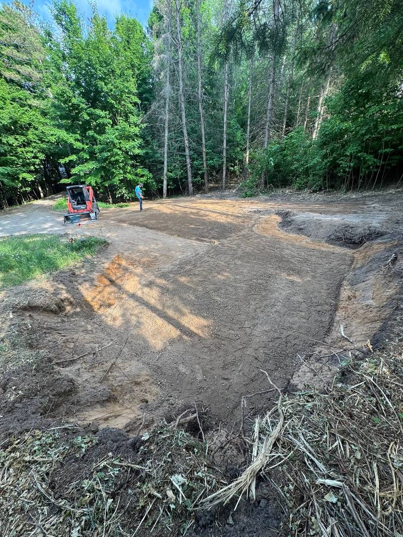 Cleared and graded lot at the edge of the woods