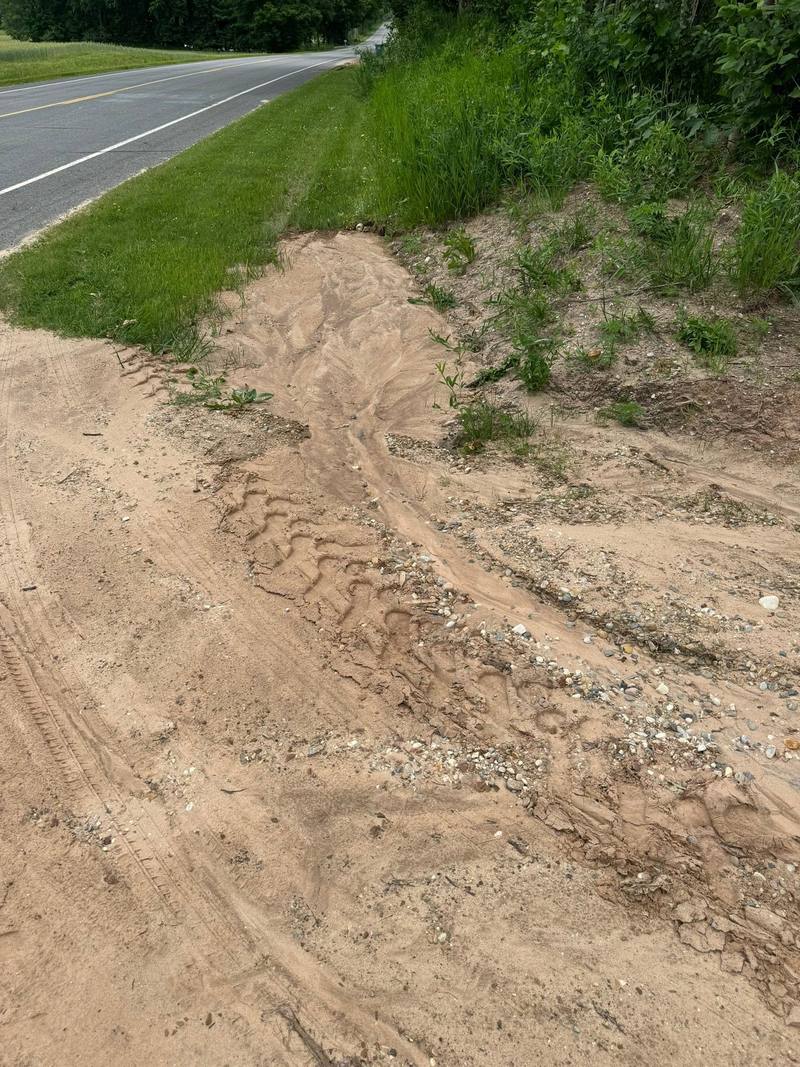 Driveway edge washed out by runoff next to the road