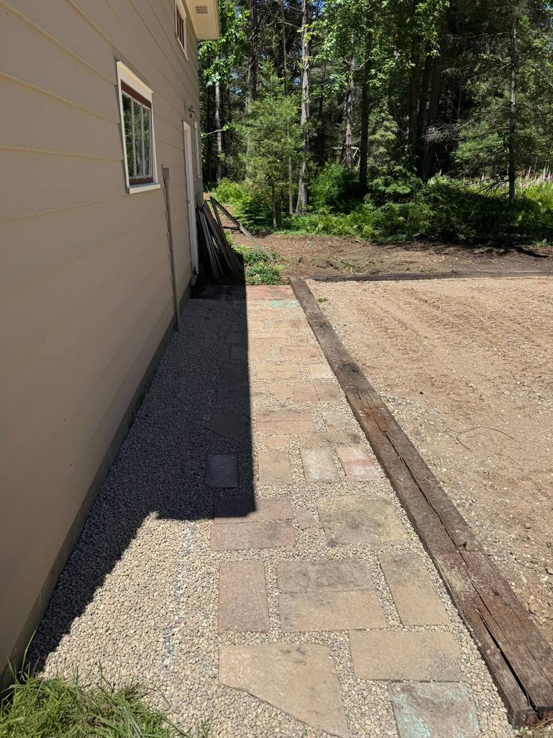 Gravel strip and paver walk along the side of a house