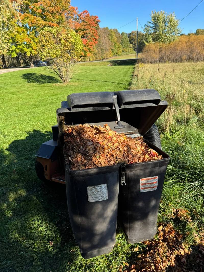 Mower leaf collector bags full of fall leaves