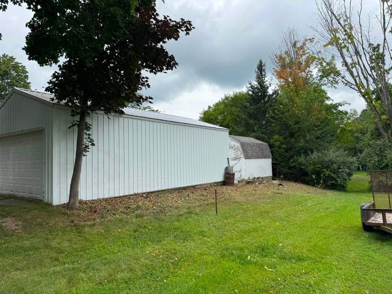 Neatly mowed side yard next to a white garage